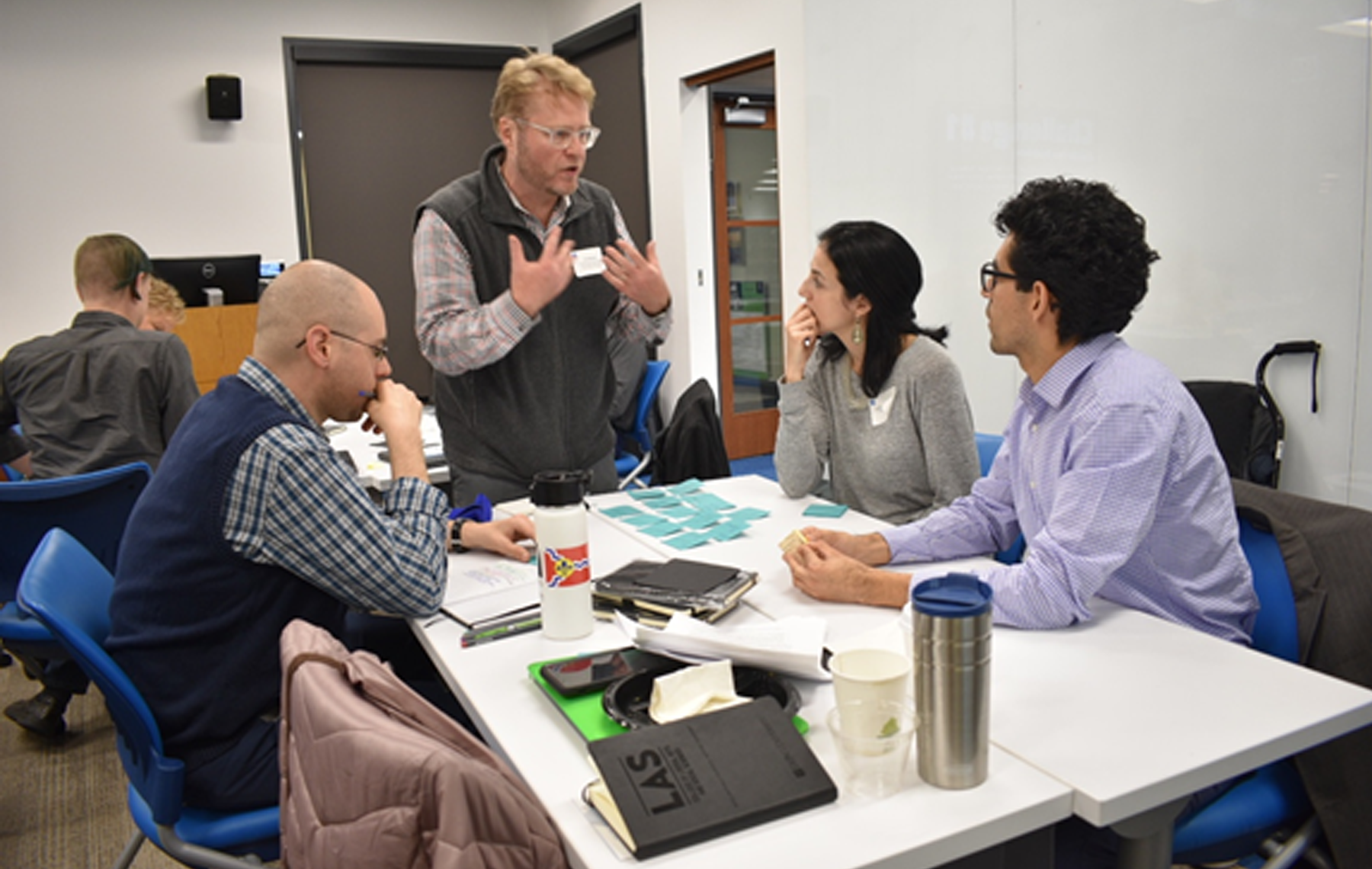 Workshop facilitator Dr. Seán McCarthy gives feedback to DePaul faculty members Carolina Barrera-Tobón (Modern Languages), Tim Elliott (Writing, Rhetoric, and Discourse), and Joe Tafoya (Political Science).