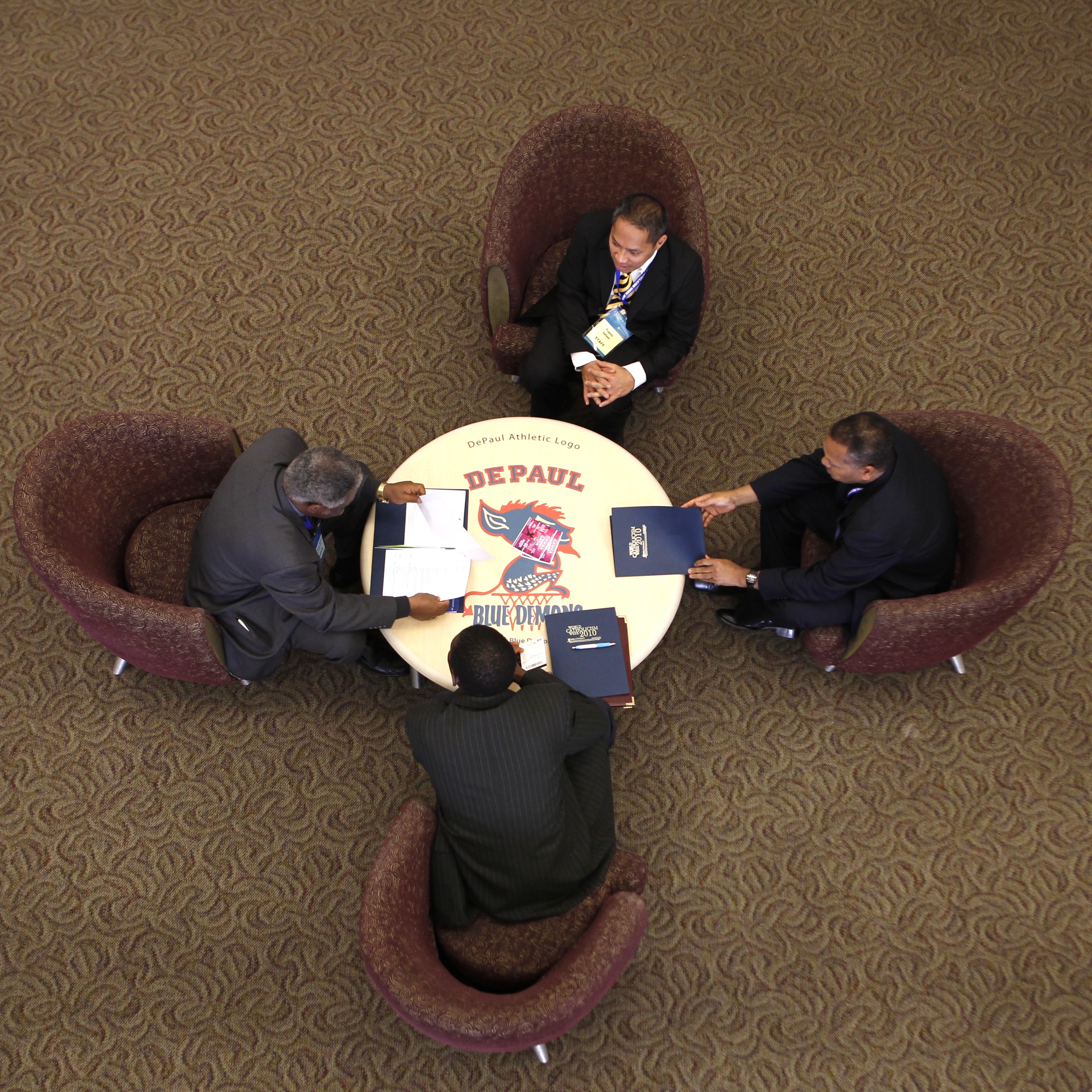 Bird's eye view of four people in conversation at a round table