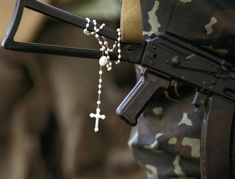 Rosary hanging from gun