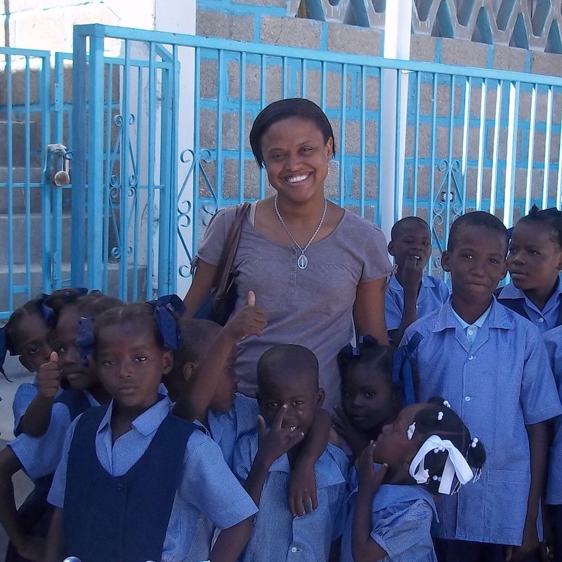 Yasmine Cajuste with Haitian school children